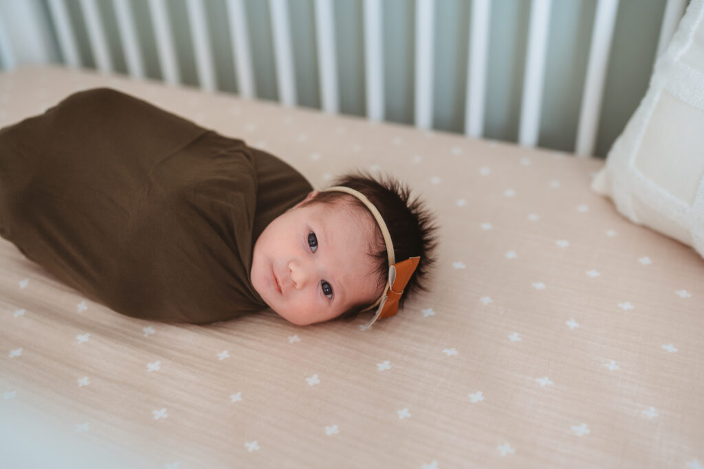 Baby girl lying in crib